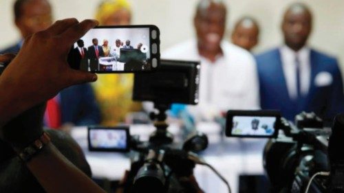 Journalist uses a phone to film as Martin Fayulu, Congolese joint opposition presidential candidate ...