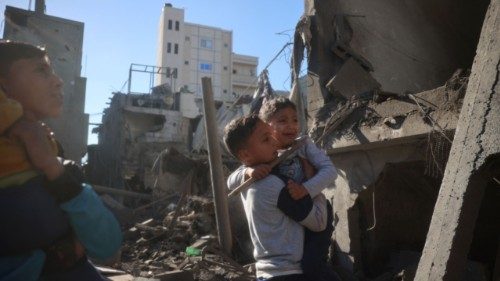 Palestinian children react as they inspect the rubble and debris at the site of Israeli strikes the ... Palestinian children react as they inspect the rubble and debris at the site of Israeli strikes the ...