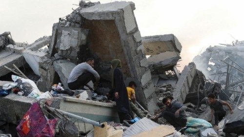 Palestinians inspect the damage at the Dar Al-Arqam school, where displaced people shelter, after it ... Palestinians inspect the damage at the Dar Al-Arqam school, where displaced people shelter, after it ...