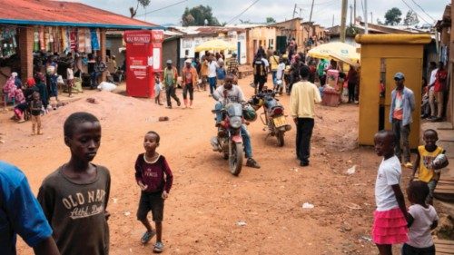 Bystanders and pedestrians move along a commercial road near the market at the Kiziba Refugee Camp ... Bystanders and pedestrians move along a commercial road near the market at the Kiziba Refugee Camp ...