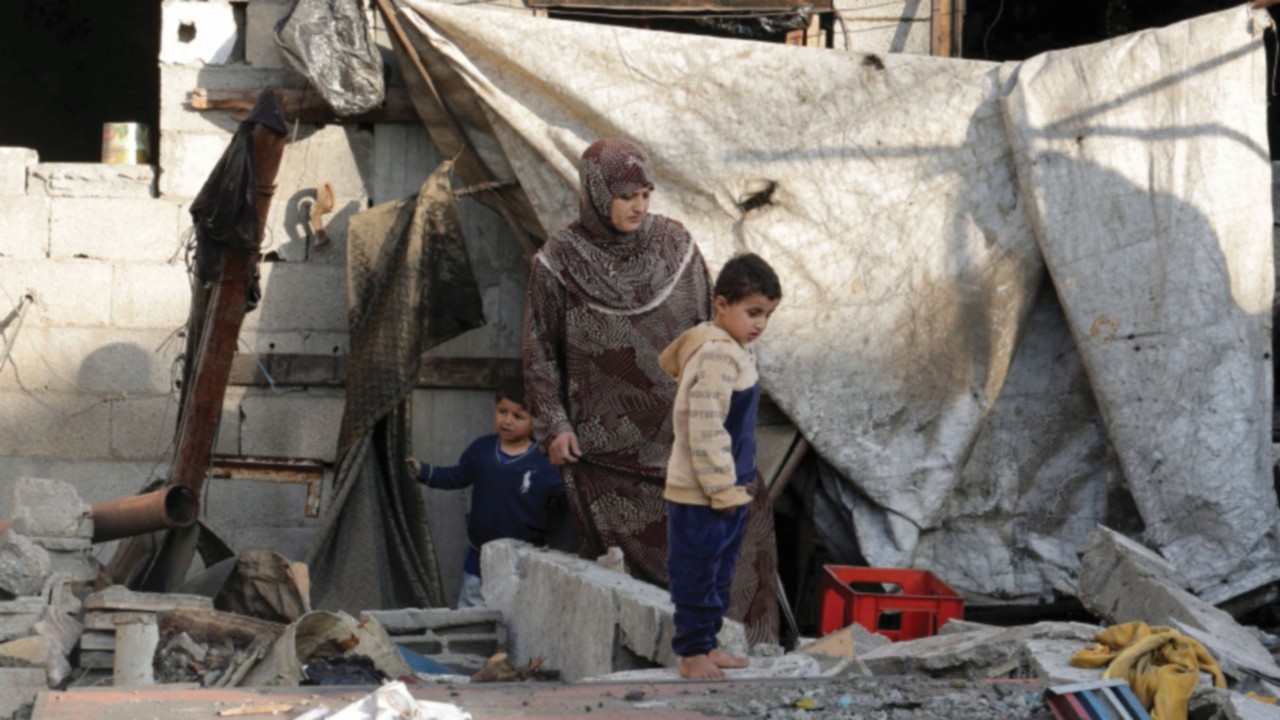Palestinians gather at the site of an Israeli strike on a house, in Khan Younis in the southern Gaza ...
