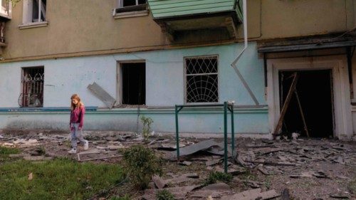TOPSHOT - A girl reacts as she walks in front of her damaged apartment building following a Russian ... TOPSHOT - A girl reacts as she walks in front of her damaged apartment building following a Russian ...