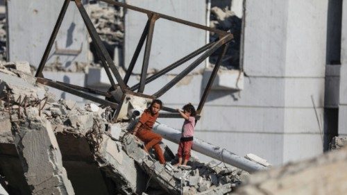 Girls are seen amid rubble as Palestinians, displaced by the Israeli military offensive, shelter in ... Girls are seen amid rubble as Palestinians, displaced by the Israeli military offensive, shelter in ...
