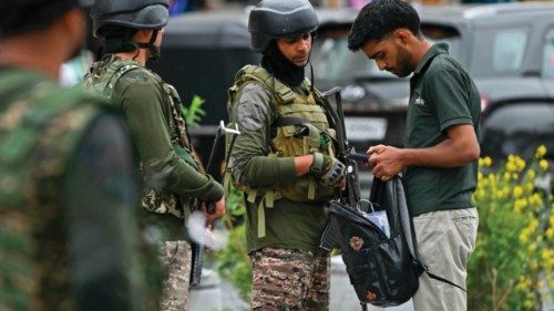 Indian paramilitary soldiers check the bag of a Kashmiri man at a marketplace in Srinagar on May 9, ... Indian paramilitary soldiers check the bag of a Kashmiri man at a marketplace in Srinagar on May 9, ...