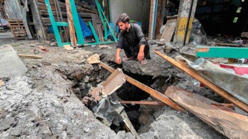 A shopkeeper sits beside the debris of his shop after cross-border shelling along the Line of ... A shopkeeper sits beside the debris of his shop after cross-border shelling along the Line of ...