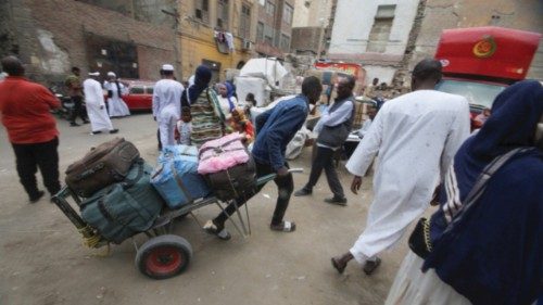 Sudanese refugees load their luggage at an assembly point for buses, arranged for their voluntary ... Sudanese refugees load their luggage at an assembly point for buses, arranged for their voluntary ...