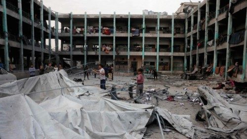 Palestinians salvage items from the rubble at the Fatima Bint Asad school hit in overnight Israeli ... Palestinians salvage items from the rubble at the Fatima Bint Asad school hit in overnight Israeli ...