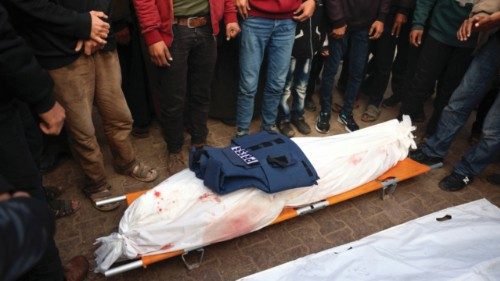 People mourn over the body of Palestinian journalist Ahmed Al-Shayah, covered with a press vest, ... People mourn over the body of Palestinian journalist Ahmed Al-Shayah, covered with a press vest, ...