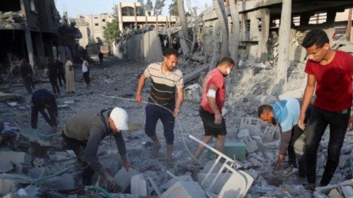 Palestinians inspect the site of an Israeli strike on a house, in Jabalia, in the northern Gaza ... Palestinians inspect the site of an Israeli strike on a house, in Jabalia, in the northern Gaza ...