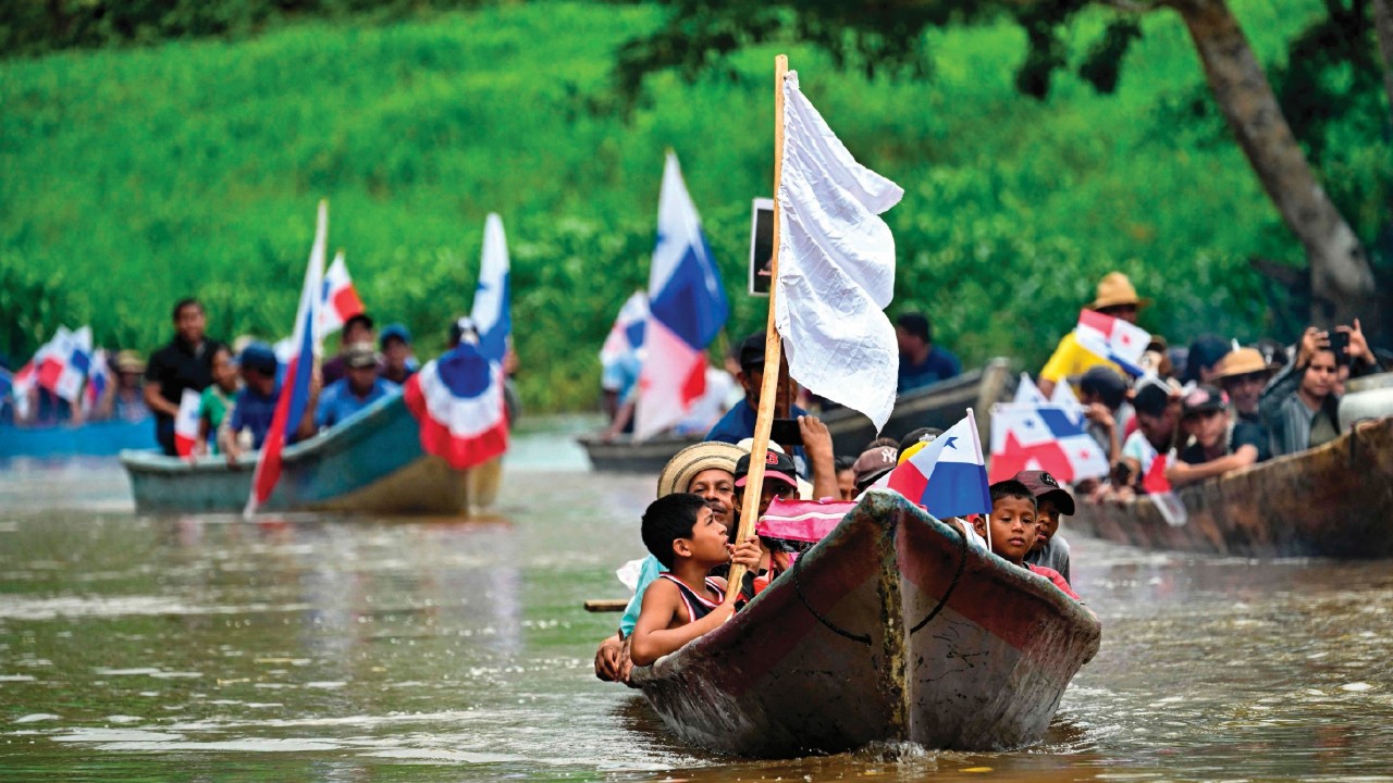 Peasants navigate the Indio River during a protest against the construction of a reservoir in the ...