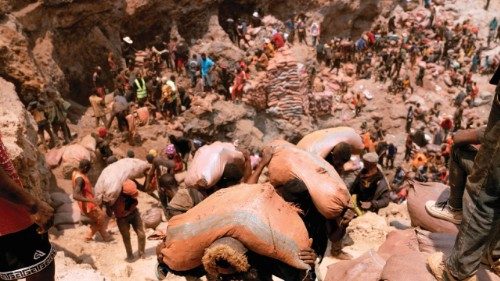 Artisanal miners carry sacks of ore at the Shabara artisanal mine near Kolwezi on October 12, 2022. ... Artisanal miners carry sacks of ore at the Shabara artisanal mine near Kolwezi on October 12, 2022. ...