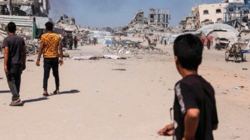 A Palestinian boy looks on as smoke billows following an Israeli drone strike in Jabalia, in the ... A Palestinian boy looks on as smoke billows following an Israeli drone strike in Jabalia, in the ...