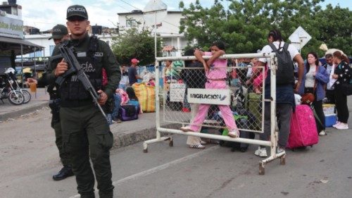 epa12129552 People wait for authorization to enter Venezuela at the Simon Bolivar International ...