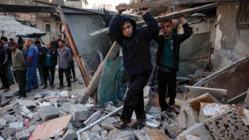 TOPSHOT - People check the destruction following an Israeli strike that hit the home of a ...