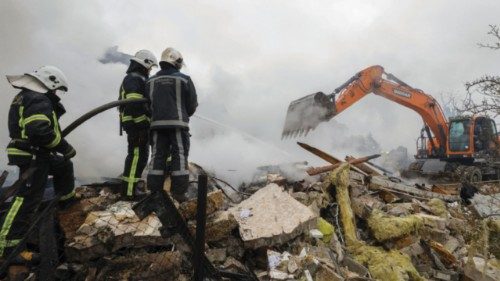 epa12133438 Ukrainian rescuers work at the site of a residential area struck by a rocket as a result ...