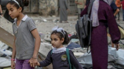 epa12136484 Palestinians sisters walk near the rubble of the Jerjawi school destroyed following an ... epa12136484 Palestinians sisters walk near the rubble of the Jerjawi school destroyed following an ...