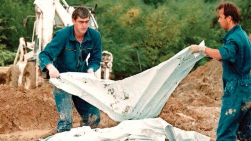 International War Crimes Criminal Tribunal investigators add a body bag to a pile of human remains ... International War Crimes Criminal Tribunal investigators add a body bag to a pile of human remains ...