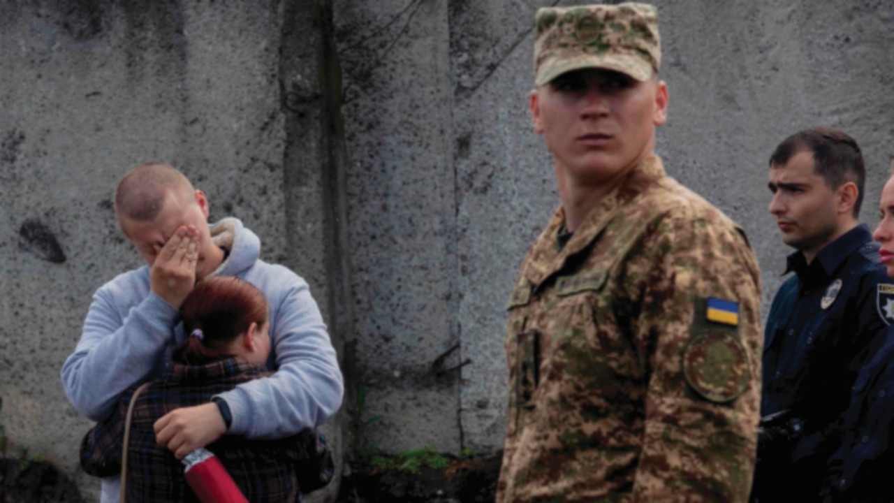 Mourners gather next to the coffin of 26-year-old Ukrainian serviceman Yaroslav Shvets, an actor and ...