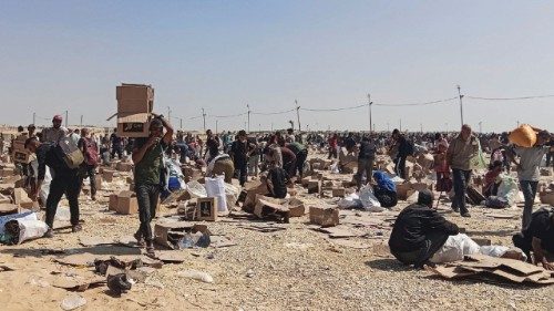 Palestinians gather to collect what remains of relief supplies from the distribution center of the ... Palestinians gather to collect what remains of relief supplies from the distribution center of the ...