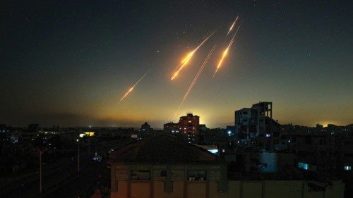TOPSHOT - This picture taken from Nuseirat, in the central Gaza Strip, shows rocket trails in the ... TOPSHOT - This picture taken from Nuseirat, in the central Gaza Strip, shows rocket trails in the ...