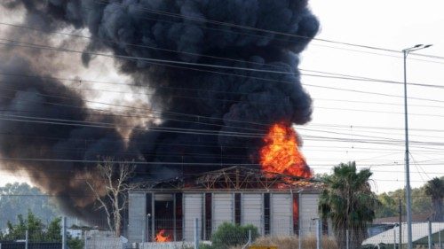 TOPSHOT - Smoke billows from a fire in a building in Herzliya near Tel Aviv following a fresh ... TOPSHOT - Smoke billows from a fire in a building in Herzliya near Tel Aviv following a fresh ...