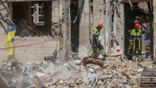 Rescuers search for the body of a person under debris of an apartment building hit by a Russian ... Rescuers search for the body of a person under debris of an apartment building hit by a Russian ...