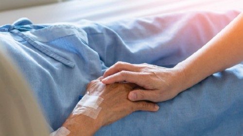 Caregiver holding elderly senior patient (ageing old adult person) hand in hospital bed or nursing ... Caregiver holding elderly senior patient (ageing old adult person) hand in hospital bed or nursing ...