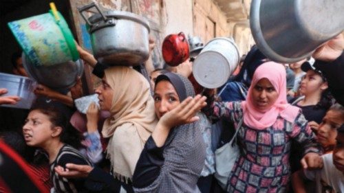 Palestinians queue at a food distribution point in Nuseirat, in the central Gaza Strip, on June 23, ... Palestinians queue at a food distribution point in Nuseirat, in the central Gaza Strip, on June 23, ...