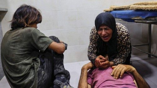 EDITORS NOTE: Graphic content / Palestinians mourn by the body of a man killed in Israeli fire at a ... EDITORS NOTE: Graphic content / Palestinians mourn by the body of a man killed in Israeli fire at a ...