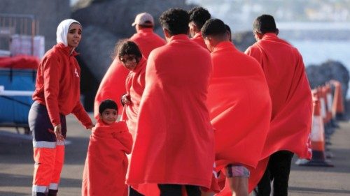 Migrants walk in the port of Arguineguin after disembarking from a Spanish coast guard vessel, in ... Migrants walk in the port of Arguineguin after disembarking from a Spanish coast guard vessel, in ...