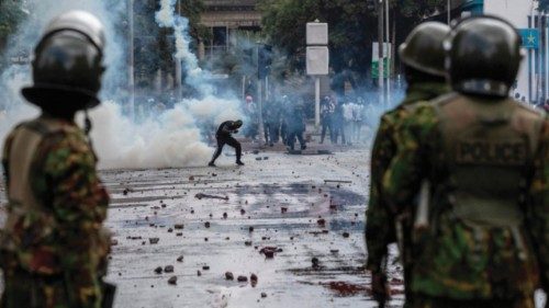 EDITORS NOTE: Graphic content / TOPSHOT - A protester ducks a teargas canister in downtown Nairobi ... EDITORS NOTE: Graphic content / TOPSHOT - A protester ducks a teargas canister in downtown Nairobi ...