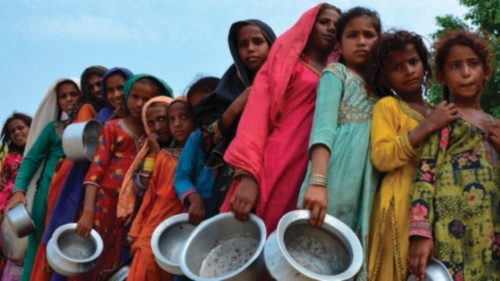 TOPSHOT - Displaced flood-affected people stand in a queue to receive food being distributed by ... TOPSHOT - Displaced flood-affected people stand in a queue to receive food being distributed by ...