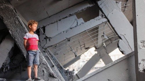 A Palestinian boy stands amidst the rubble at the grounds of Yaffa School in the Tuffah ...