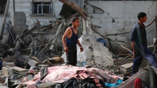 Palestinian children check the rubble of a residential house in Deir el-Balah in the central Gaza ...