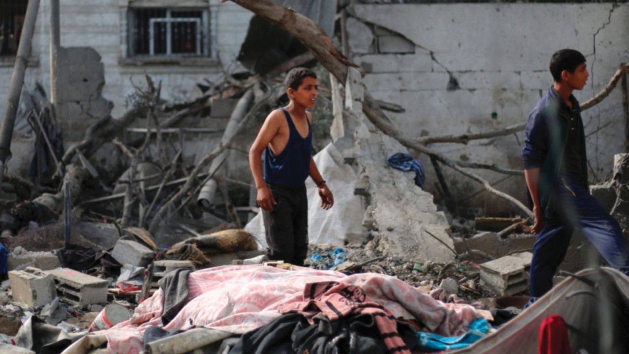 Palestinian children check the rubble of a residential house in Deir el-Balah in the central Gaza ...