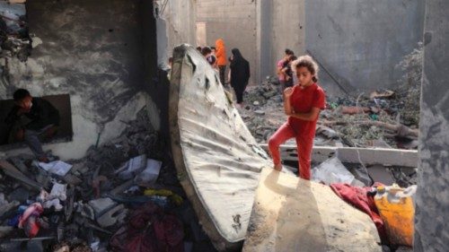 Palestinian children check the rubble of a residential house in Deir el-Balah in the central Gaza ...