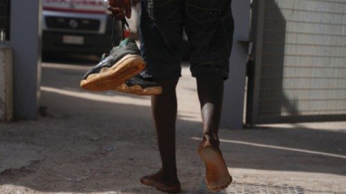 A migrant walks through the port after arriving on the Italian island of Lampedusa, on September 18, ... A migrant walks through the port after arriving on the Italian island of Lampedusa, on September 18, ...
