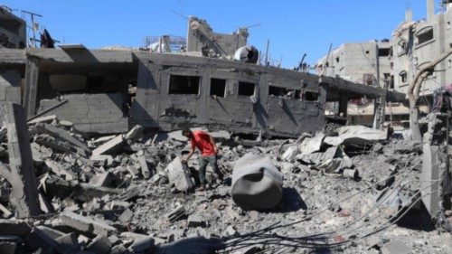 A Palestinian man inspects the damage after an Israeli strike in the Al-Bureij camp in the central ... A Palestinian man inspects the damage after an Israeli strike in the Al-Bureij camp in the central ...