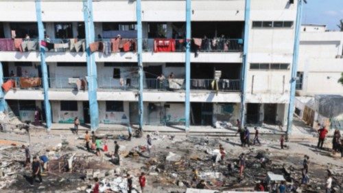 Palestinians inspect the site of an overnight Israeli strike on a school sheltering displaced ... Palestinians inspect the site of an overnight Israeli strike on a school sheltering displaced ...