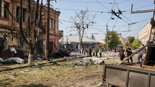 epa12222260 Emergency services inspect the site of a drone strike on a residential area in Kharkiv, ...