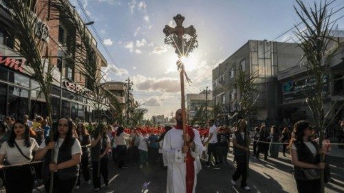 An Iraqi Chaldean Catholic priest leads a Palm Sunday service march outside the Saint Elijah church ... An Iraqi Chaldean Catholic priest leads a Palm Sunday service march outside the Saint Elijah church ...