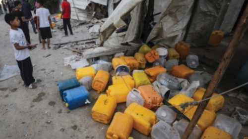 People inspect the site of an Israeli strike that killed Palestinians, gathered to collect water ... People inspect the site of an Israeli strike that killed Palestinians, gathered to collect water ...