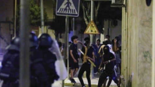 A man throws an object at police, amid anti-migrant unrest following an attack on an elderly man by ... A man throws an object at police, amid anti-migrant unrest following an attack on an elderly man by ...