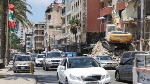 Cars drive near a building damaged during previous hostilities between Israel and Hezbollah, in the ... Cars drive near a building damaged during previous hostilities between Israel and Hezbollah, in the ...