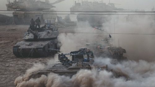 An Israeli APC manoeuvres next to other military vehicles on the Israeli side of the Israel-Gaza ...
