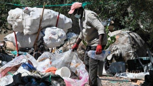 A ragpicker sorts through plastics collected from the garbage in the working-class neighborhood of ...