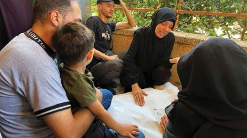 Mourners react next to the body of a Palestinian, who according to medics, was killed in overnight ...