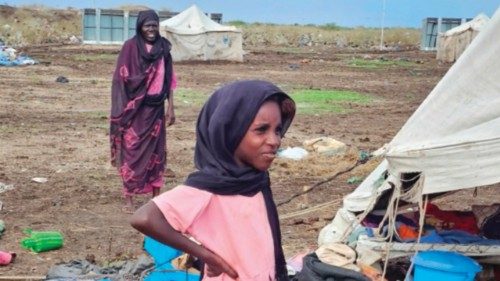 A displaced Sudanese child stands in front of a damaged tent following heavy rainfall, at the Abu ...