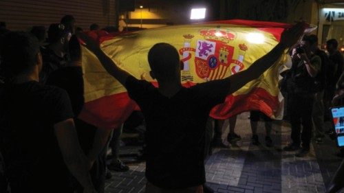 epa12240278 A demonstrator raises a Spanish national flag during a protest in the town of Torre ...