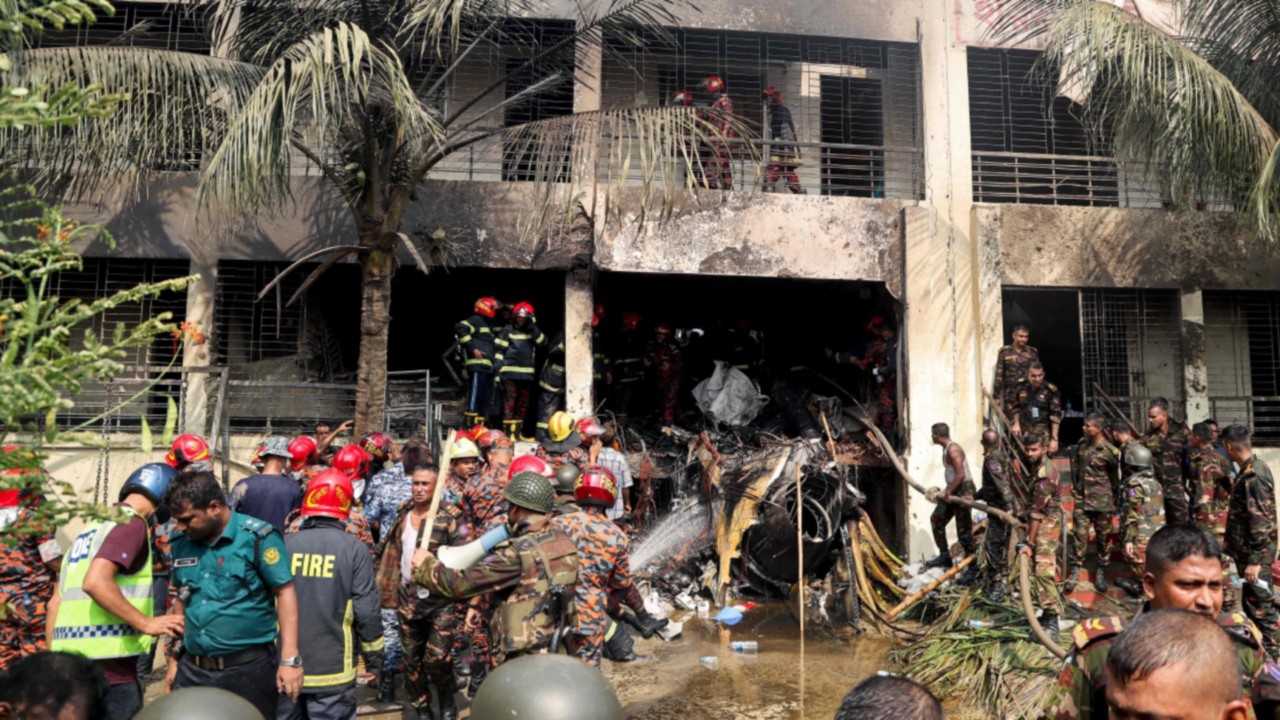 Bangladesh's fire service and security personnel conduct a search and rescue operation after an Air ...